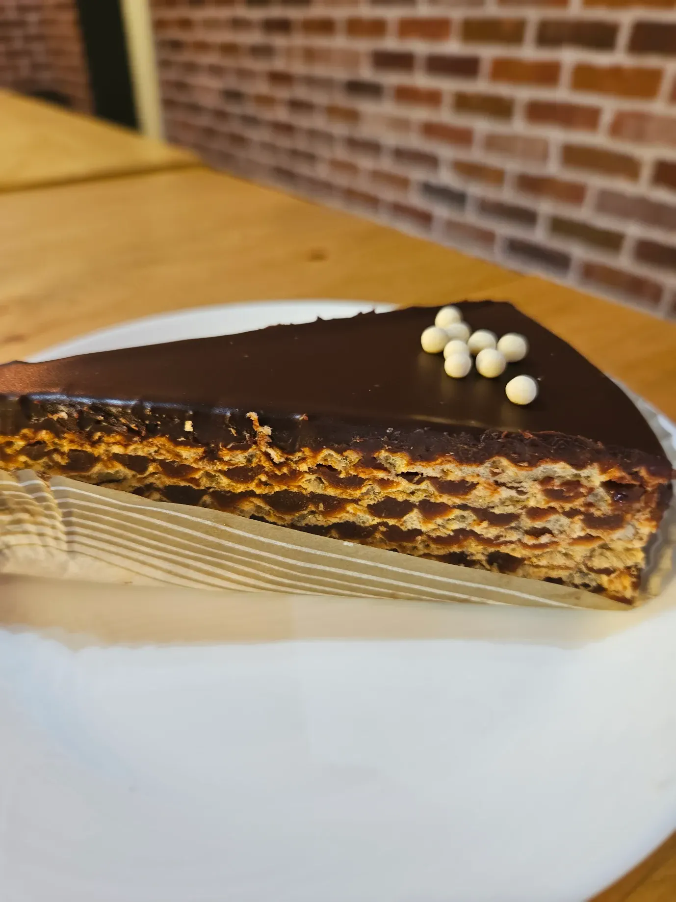 Chocolate wafer torte slice with white chocolate pearls