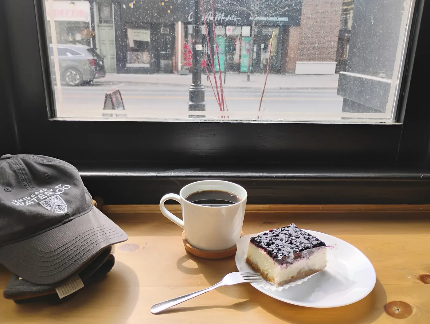 Coffee and blueberry cheesecake at the window seat