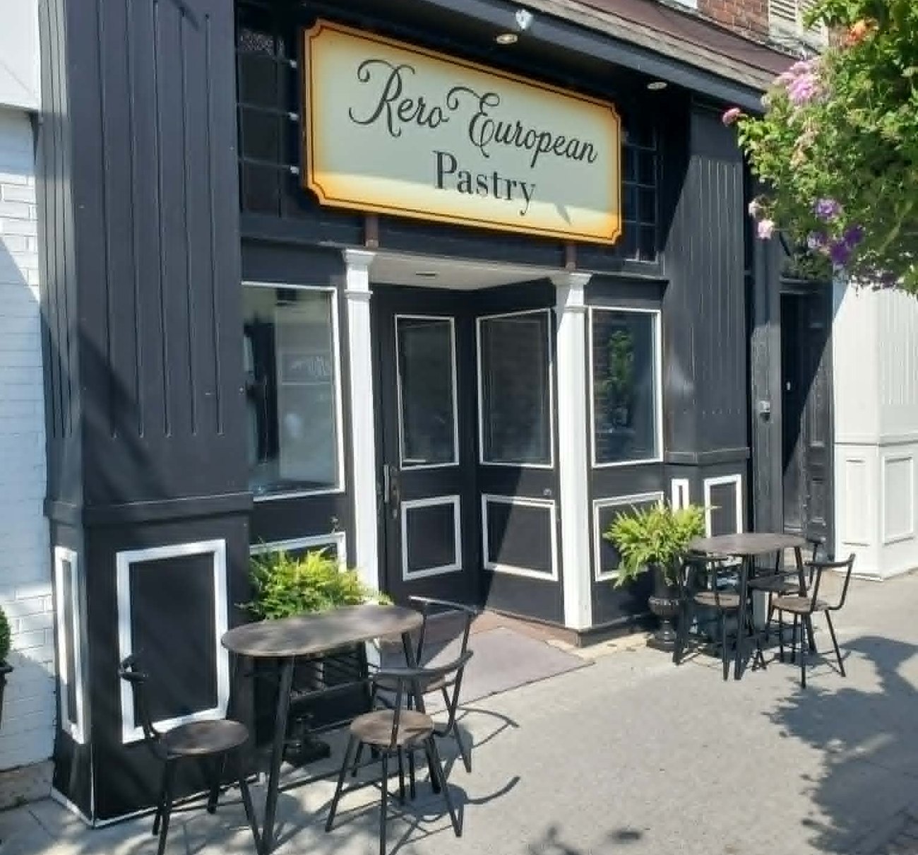 The Rero European Pastry storefront on King Street West, with tables and chairs on the sidewalk under the shop sign